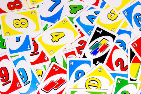 MINSK, BELARUS - MARCH 30, 2021: Top view of table leisure family game Uno playing cards as a colorful textured background.のeditorial素材