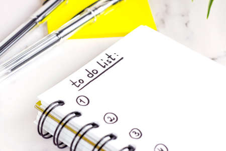 To do list in the planning notepad with the checklist and copy space on light background. Office management and education reminder concept.の写真素材