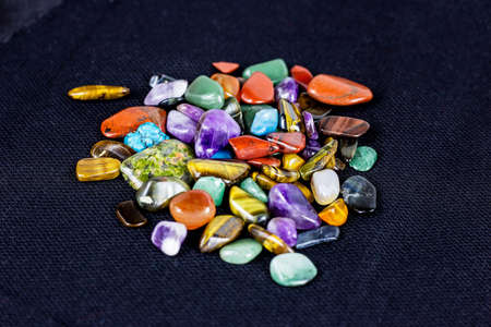 Different colorful gemstones on dark background. Stone therapy, spiritual healing, crystal energy, lithotherapy, esoteric meditation and magic concept.の写真素材