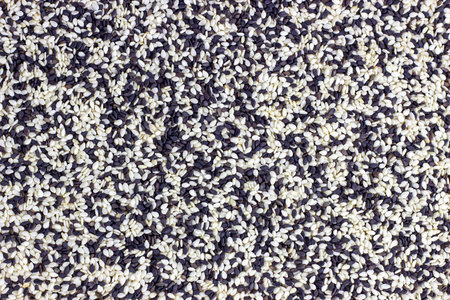 Top view of black and white mix sesame seeds texture as a food background.