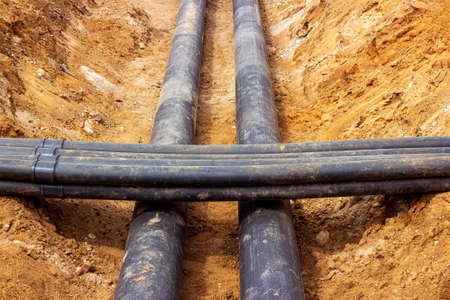 Installation of the distribution unit of heating and water supply network. Frame for connecting pipes in the trench of ground.の写真素材