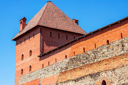 LIDA, BELARUS - JULY 10, 2021: Archeological monument medieval stone Lida castle, historical show place for tourists in summer.のeditorial素材