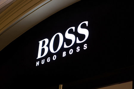 MOSCOW, RUSSIA - AUGUST 10, 2021: Hugo Boss brand retail shop logo singboard on the storefront in the shopping mall.のeditorial素材