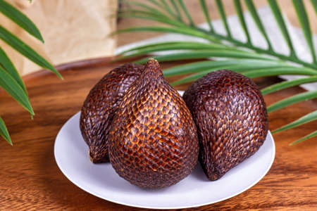Fresh brown tropical salak fruit ripe on wooden background close upの写真素材