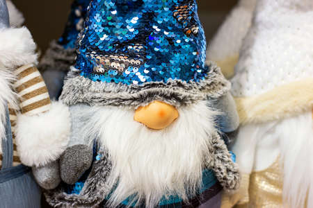 Colorful funny Christmas gnome from Nordic folklore (Nisse, Tomte, Tonttu, Tomtenisse), dolls with blue hat and long white beard. Traditional Scandinavian Xmas and winter solstice symbol.の写真素材