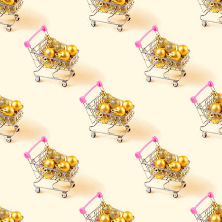 Trolley shopping cart with golden Xmas baubles on light background repeat seamless pattern. Christmas sale, discounts, holiday shopping wrapping paper design.の写真素材