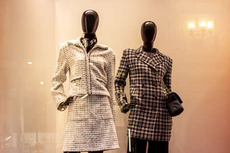 Fashionable women mannequins in trendy casual clothes on the clothing retail store window in the shopping mall.の写真素材