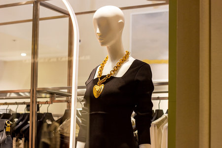 Fashionable women mannequins in trendy casual clothes on the clothing retail store window in the...