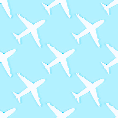 White plane silhouette repeat seamless pattern on light blue background.