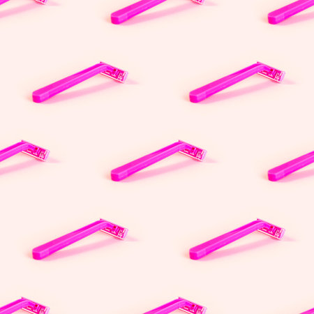 Pink disposable woman razor repeat seamless pattern on light pastel background. Hair removing, epilation procedure and shaving wrapping paper design.の写真素材