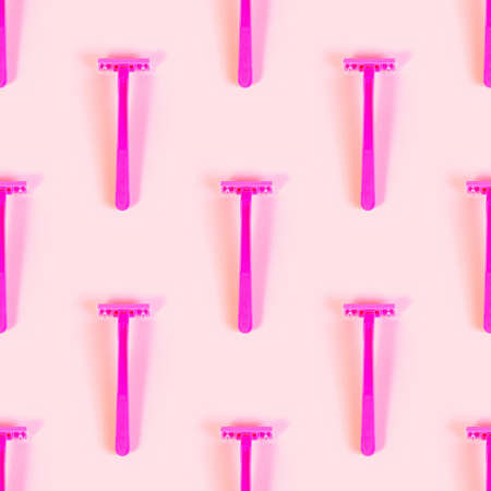 Pink disposable woman razor repeat seamless pattern on light pastel background. Hair removing, epilation procedure and shaving wrapping paper design.の写真素材