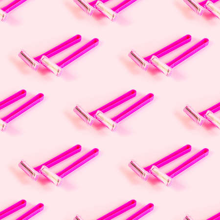Pink disposable woman razor repeat seamless pattern on light pastel background. Hair removing, epilation procedure and shaving wrapping paper design.の写真素材