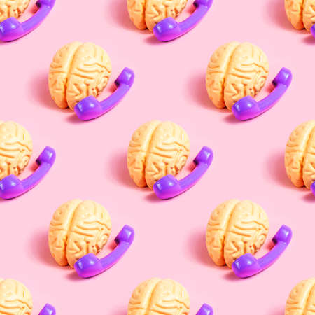 Human brain using dial phone repeat seamless pattern on light pink background.の写真素材