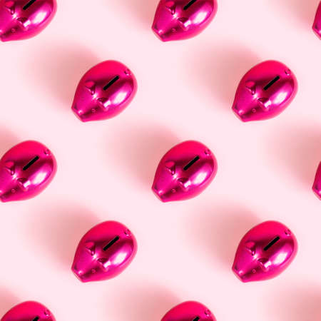 Bright pink piggy bank for coins repeat seamless pattern on light rose background.の写真素材
