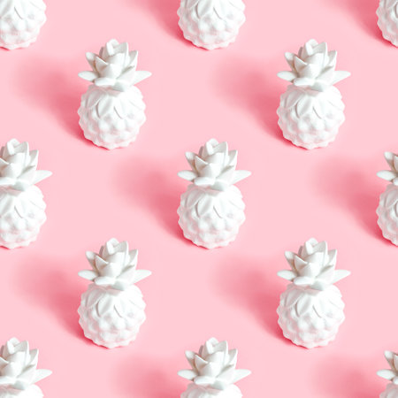 White pineapple tropical fruit repeat seamless pattern on light pastel pink background for wrapping paper.の写真素材