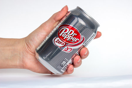 DUSHANBE, TAJIKISTAN - SEPTEMBER 11, 2022: Woman hands holding the silver aluminium Dr. Pepper Zero can close up on white background.のeditorial素材