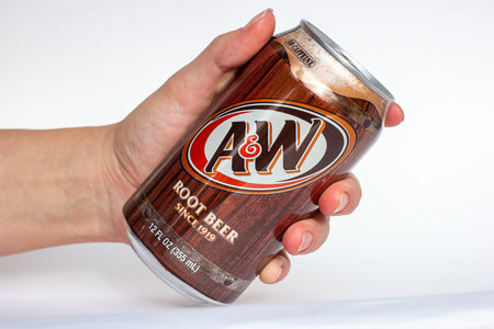 DUSHANBE, TAJIKISTAN - SEPTEMBER 11, 2022: Woman hand holding the aluminium AW root beer can close...