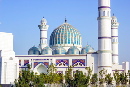 DUSHANBE, TAJIKISTAN - AUGUST 11, 2022: White building of Central Cathedral Mosque of Dushanbe with mosaic ornament against the blue sky.のeditorial素材