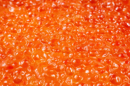 Bright red salmon fish caviar background close up.の写真素材