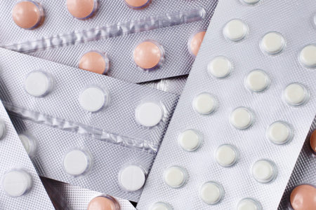 Top view of silver foil blister packs with medical pills close up.の写真素材