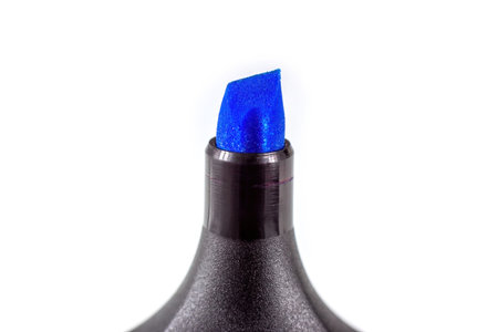 Black marker pen with bright blue tip on light background close up with copy space.の写真素材