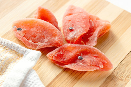 Dried tropical organic natural passion fruit with sugar on the wooden board background in the kitchen.の写真素材