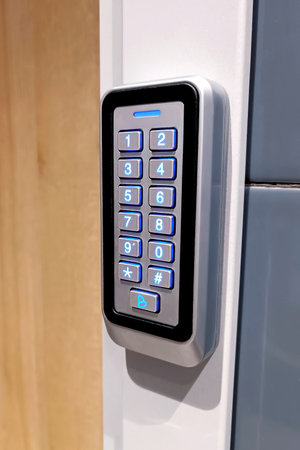 Black metal electric code lock with the digital keypad and card access near the house entrance door.の写真素材
