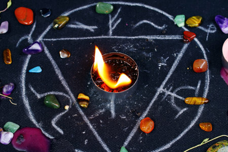 Black magic ritual background with magical altar, candles, crystals and herbs. Sorcerer rite of witchcraft and occultism. Halloween occult, esoteric and divination concept.の写真素材