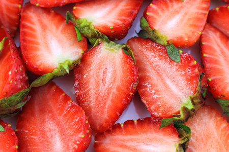 Bright red fresh juicy strawberries slices close up top view.の写真素材