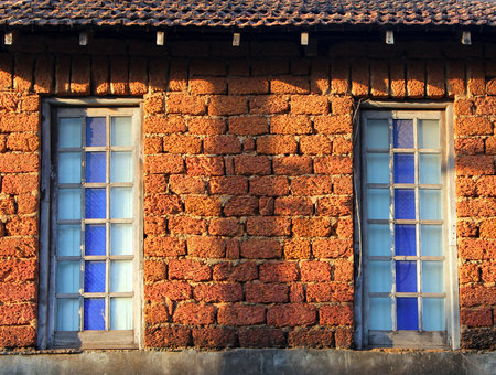 windows of rural stone house in the rays of the setting sunの写真素材
