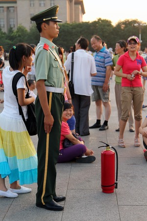 BEIJING - July 3  a soldier stands guard at the Tiananmen square in Beijing, China on july 3, 2011  Crowds of people come to the capital to visit the main square in front of the Forbidden Cityのeditorial素材
