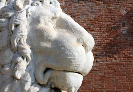 Ancient stone lion statue at the gates of Arsenal, Venice, Italyの写真素材
