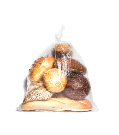 Different kinds of bread in transparent bag isolated on whiteの写真素材