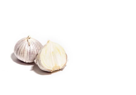 Whole garlic and half sliced isolated on whiteの写真素材