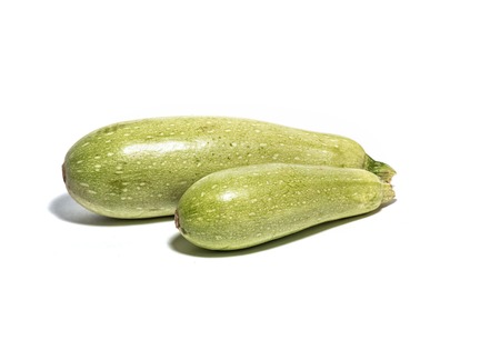 Big and small zucchini isolated on white. Copy spaceの写真素材