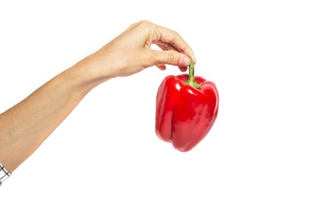 hand holds red pepper isolated on white backgroundの写真素材