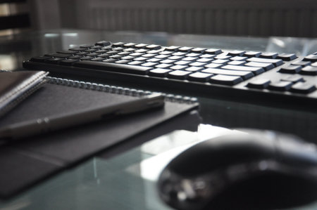 keyboard, mouse note pad and pen on desk