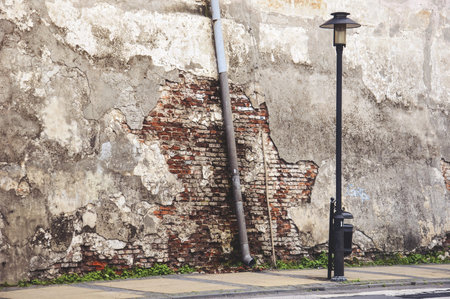 ruined plaster on the house in the downtown streetの写真素材