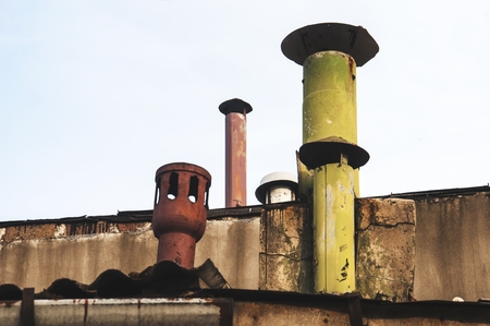different kind of chimneys on the rooftopの写真素材