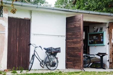 old fashioned bicycle and a small garageの写真素材