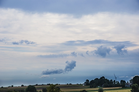 fields in the village with the blue sky and cloudsの写真素材