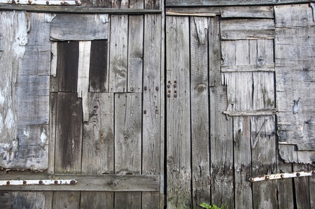 background of wooden old doors made of planksの写真素材