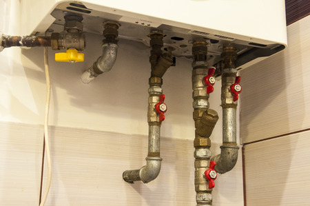 a water and gas pipes coming from bathroom boiler heaterの写真素材
