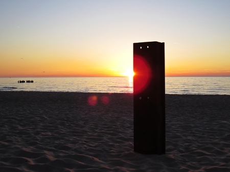 Beach Seaside during Sunset with a Harbor Haven and Breakwatersの写真素材