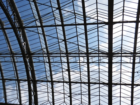 Historical Glass Roof with Cloudy Sky of the Prague Main Train Station Terminalの写真素材