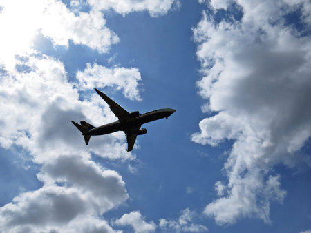 Airplane Plane Aircraft Flying in a Blue Sky with White Clouds, July 2018, Warsaw, Poland