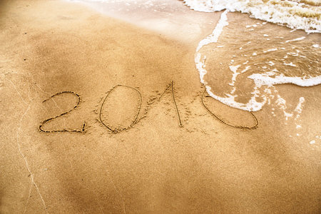 2016 year drawing on the sand washed away by the way