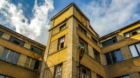 Abandoned old factory building under the blue cloudy sky