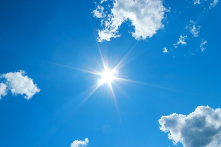 Sun in blue sky. Sunshine in blue sky with white cloudsの写真素材