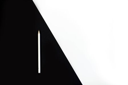 white pencil on black and white backgroundの写真素材